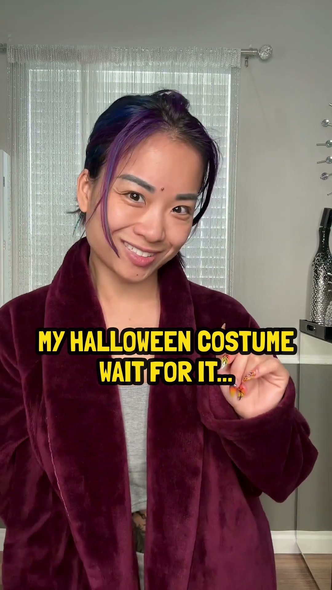 Katie in a burgundy robe with the caption: My Halloween costume, wait for it
